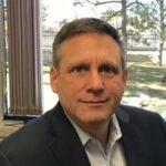 Chad a man smiling at the camera